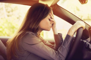 Traffic Ticket Attorney - Stressed woman driver sitting inside her car